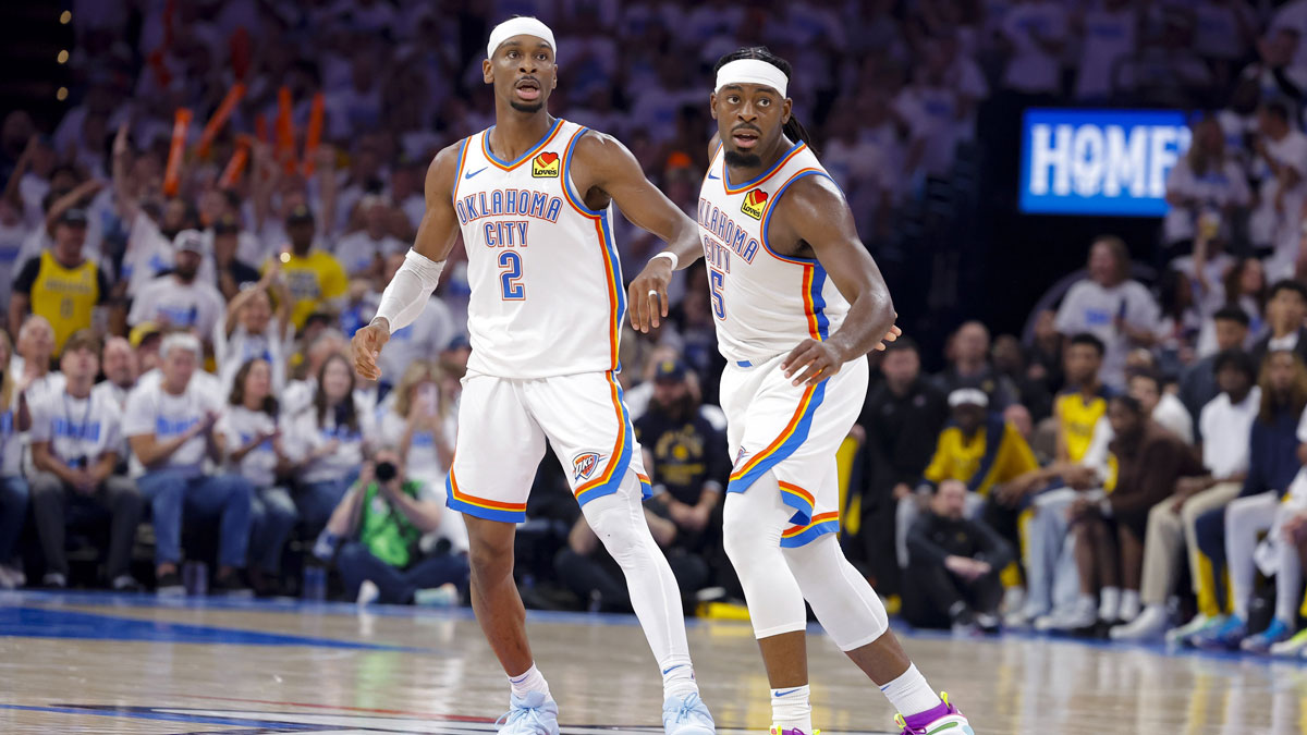 Oklahoma City Thunder guard Shai Gilgeous-Alexander (2) and guard Luguentz Dort (5) look on during the third quarter against the Indiana Pacers during game one of the 2025 NBA Finals at Paycom Center.