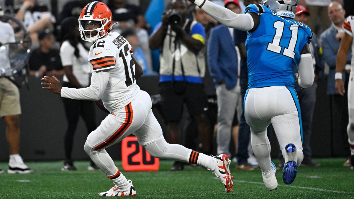 Cleveland Browns quarterback Shedeur Sanders (12) scrambles as Carolina Panthers linebacker Nic Scourton (11) pressures in the second quarter at Bank of America Stadium.