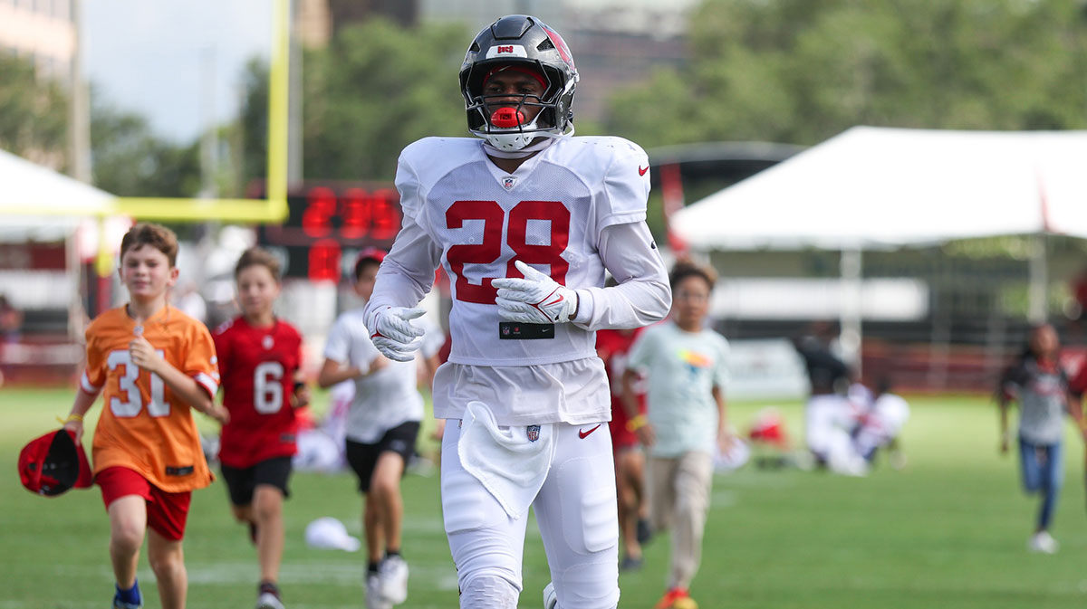 Aug 1, 2025; Tampa, FL, USA; Tampa Bay Buccaneers safety Shilo Sanders (28) runs with fans after training camp at AdventHealth Training Center.