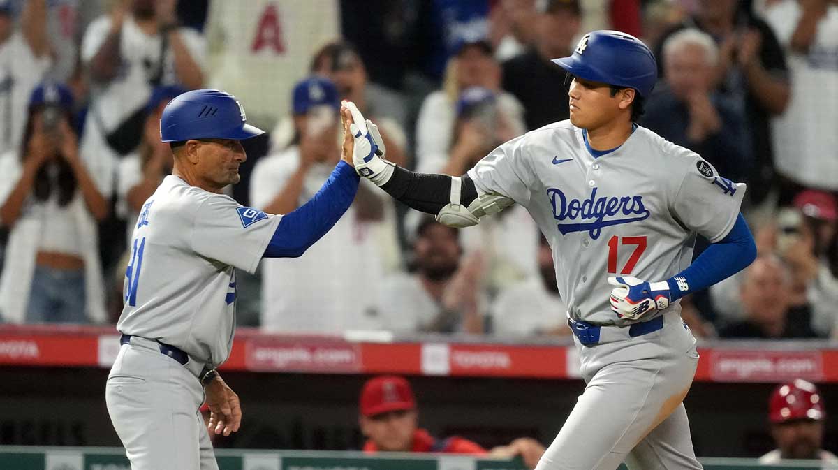 Aug 11, 2025; Anaheim, California, USA; Los Angeles Dodgers designated hitter Shohei Ohtani (17) celebrates with third base coach Dino Ebel (91 hitting a home run in the eighth inning against the Los Angeles Angels at Angel Stadium. 