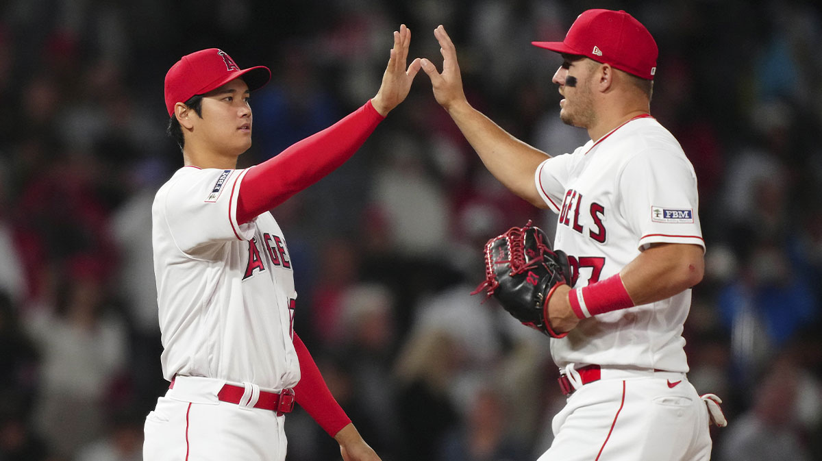Los Angeles Angels designated hitter Shohei Ohtani (17) and center fielder Mike Trout (27) celebrate after the game against the Boston Red Sox at Angel Stadium.
