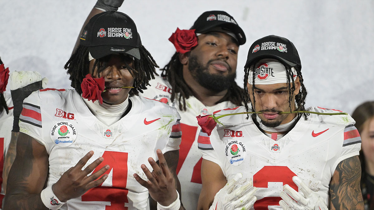 Ohio State Buckeyes wide receiver Emeka Egbuka (2) and wide receiver Jeremiah Smith (4) celebrate on the podium after defeating the Oregon Ducks in the 2025 Rose Bowl college football quarterfinal game at Rose Bowl Stadium.