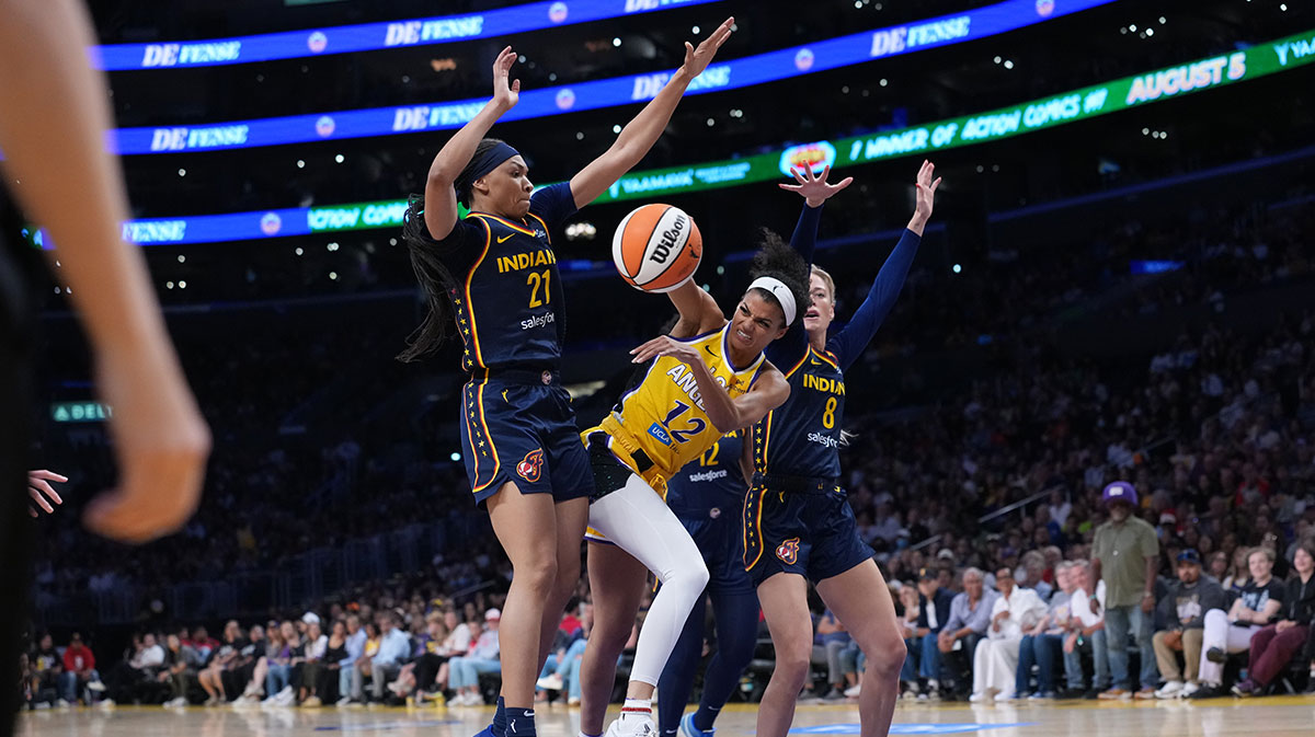 LA Sparks guard Rae Burrell (12) is double teamed in the pain by Indiana Fever guard Sophie Cunningham (8) and forward Makayla Timpson (21) in the first half at Crypto.com Arena.
