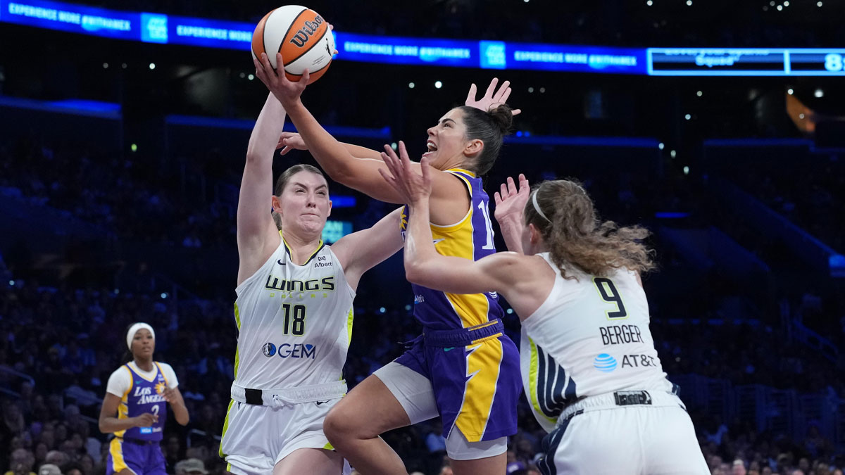LA Sparks guard Kelsey Plum (10) shoots the ball against Dallas Wings center Luisa Geiselsoder (18) and guard Grace Berger (9) in the first half at Crypto.com Arena.