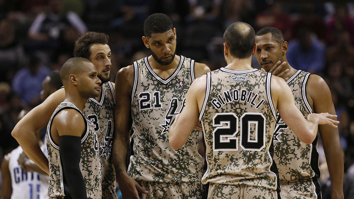 Spurs guard Manu Ginobili (20) talks with teammates (from left) Patrick Mills, and Marco Belinelli, and Tim Duncan, and Boris Diaw during the second half against the Charlotte Bobcats at AT&T Center. The Spurs won 92-82