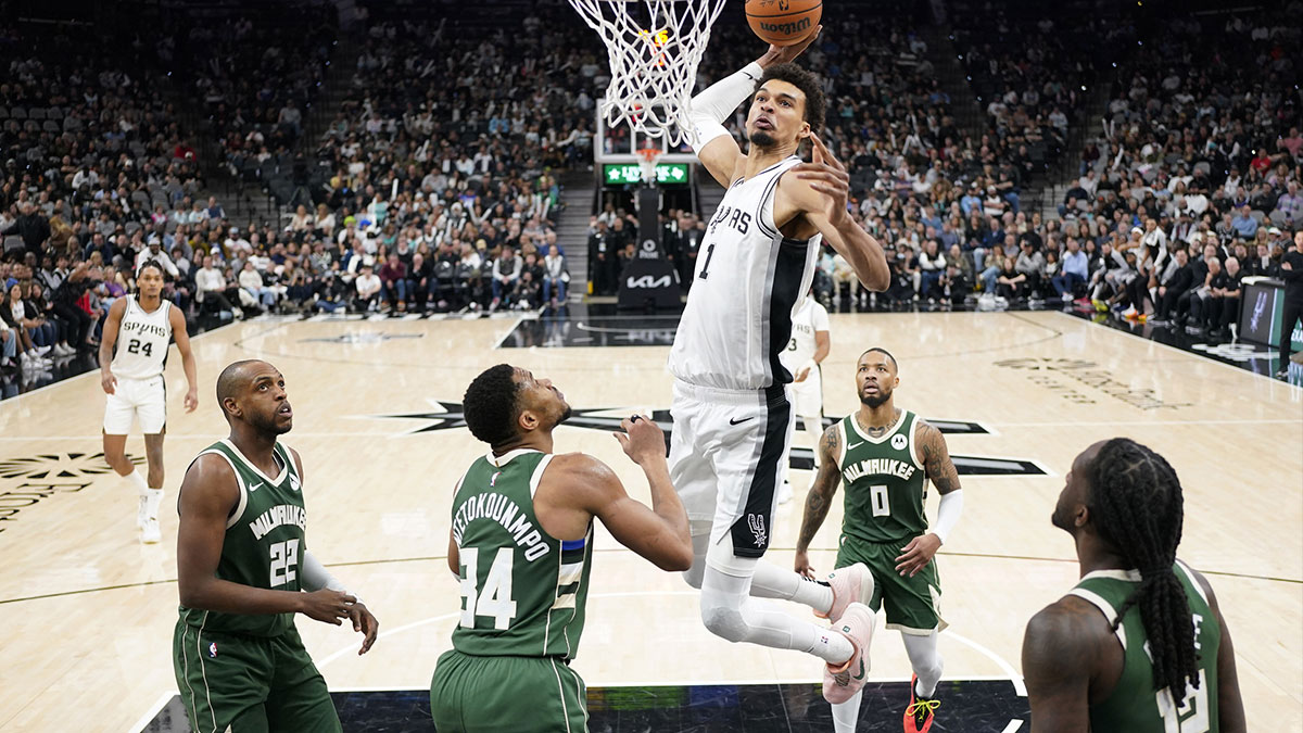 San Antonio Spurs center Victor Wembanyama (1) dunks over Milwaukee Bucks forward Giannis Antetokounmpo (34) during the second half at Frost Bank Center.