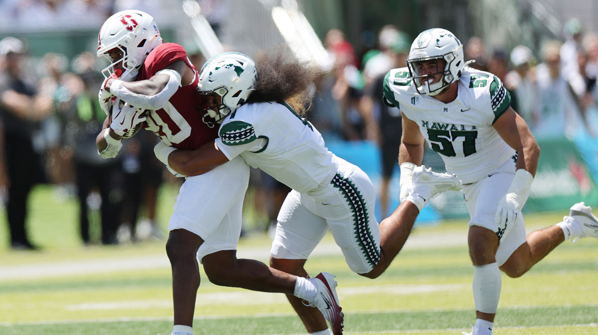 Hawaii Rainbow Warriors defensive back Peter Manuma (1) tries to pull down Stanford Cardinal running back Micah Ford (20) during the first half of an NCAA college football game at Clarence T.C. Ching Athletics Complex.