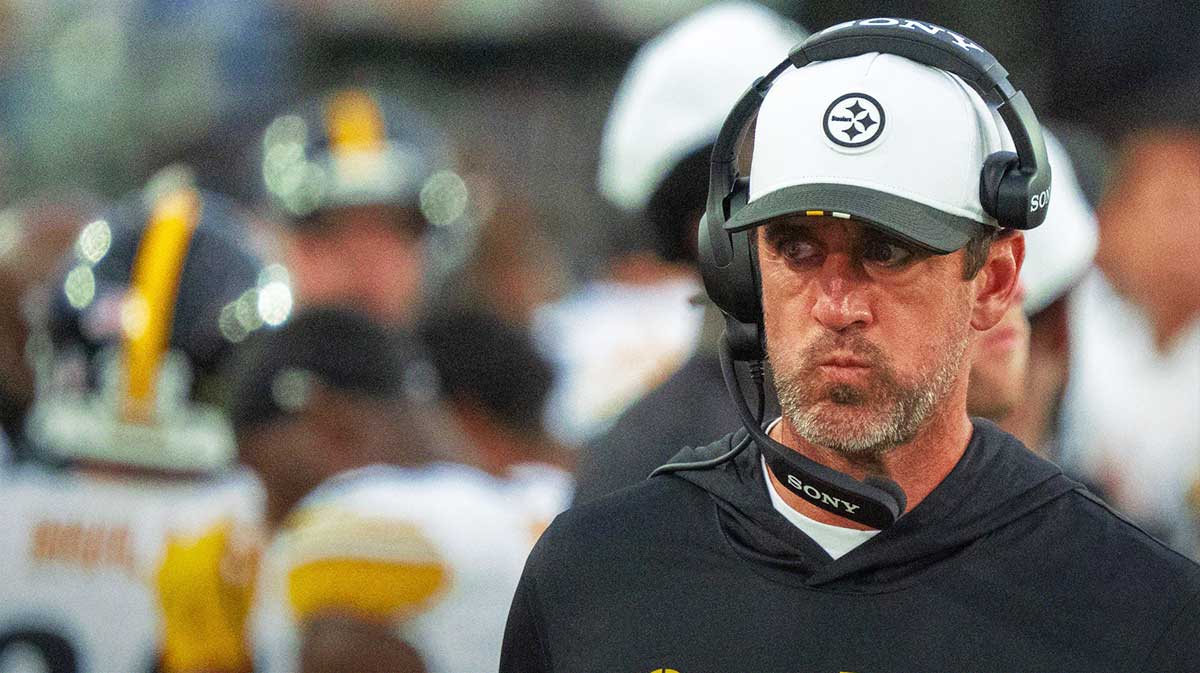 Steelers quarterback Aaron Rodgers (8) walks along the sideline with a head set during the first half of the first preseason game where the Jacksonville Jaguars hosted the Pittsburgh Steelers Saturday Aug. 9, 2025, at EverBank Stadium in Jacksonville, Fla. with Steelers' Zach Frazier and Steelers' Mason McCormick
