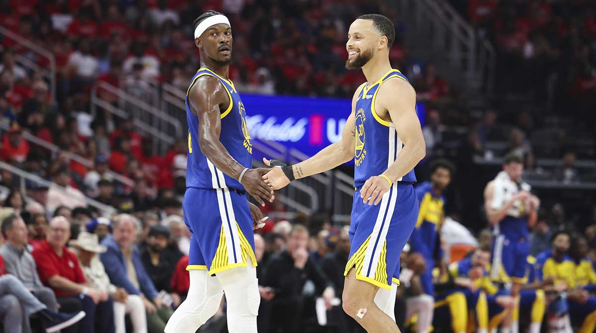 Golden State Warriors guard Stephen Curry (30) celebrates with forward Jimmy Butler III (10) after a play during the second quarter against the Houston Rockets at Toyota Center.