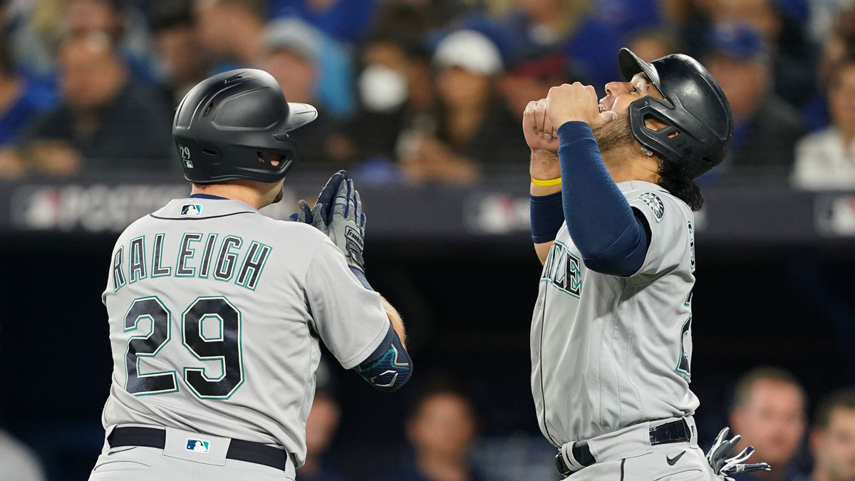 Seattle Mariners catcher Cal Raleigh (29) celebrates his two run home run with third baseman Eugenio Suarez (28) in the first inning against the Toronto Blue Jays during game one of the Wild Card series for the 2022 MLB Playoffs at Rogers Centre.