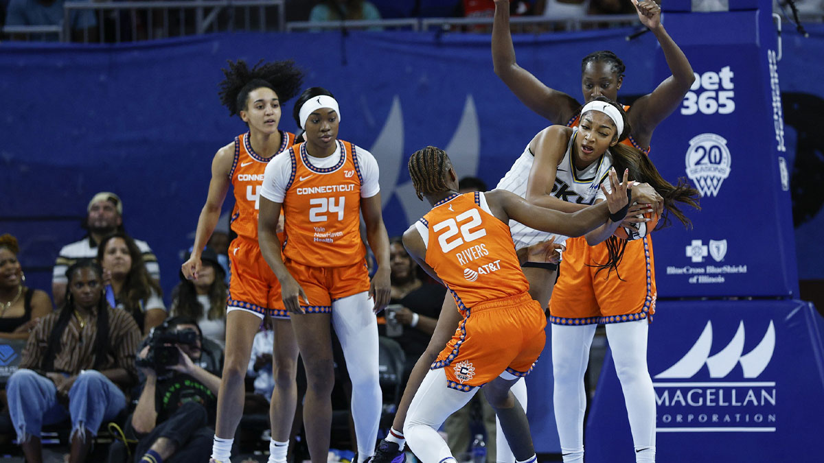Connecticut Sun guard Saniya Rivers (22) battles for the ball with Chicago Sky forward Angel Reese (5) during the first half at Wintrust Arena.