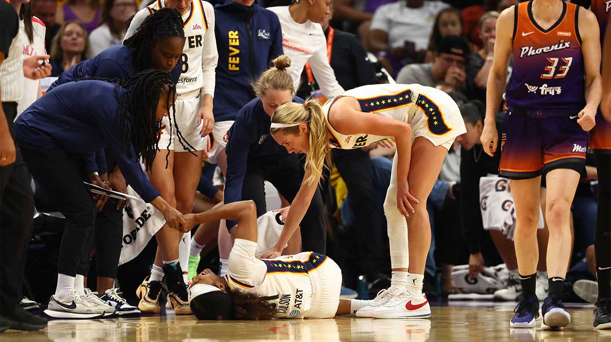 Indiana Fever guard Sydney Colson (51) reacts after suffering an injury alongside Phoenix Mercury guard Sami Whitcomb (33) in the first half of a WNBA game at PHX Arena.