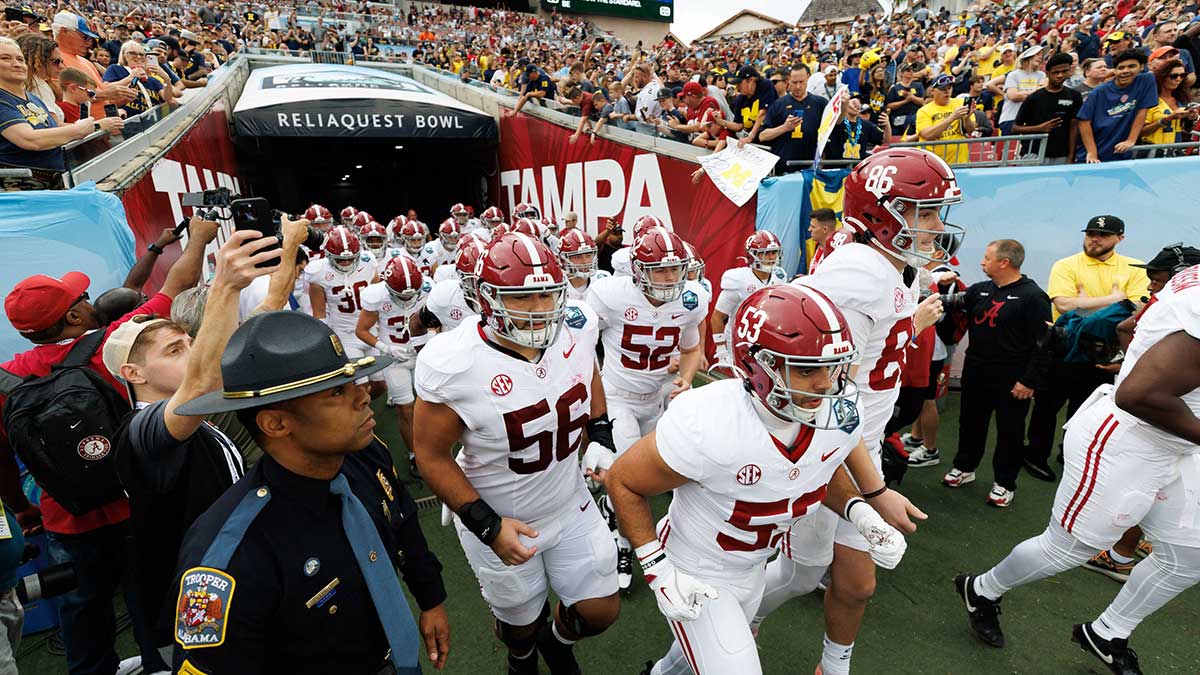 Alabama Crimson Tide linebacker Vito Perri (53) and Alabama Crimson Tide punter James Burnip (86) lead the team onto the field before a game against the Michigan Wolverines at Raymond James Stadium.