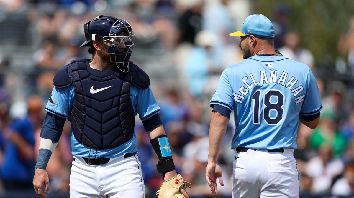 Tampa Bay Rays pitcher Shane McClanahan (18) talks to catcher Danny Jansen (19) against the New York Mets in the first inning during spring training at Charlotte Sports Park.