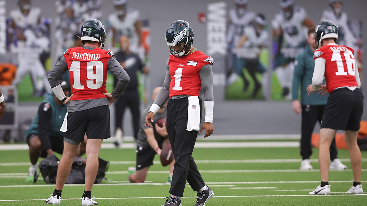Philadelphia Eagles quarterback Jalen Hurts (1) walks between Tanner McKee (16) and Kyle McCord (19) during OTAs at NovaCare Complex.