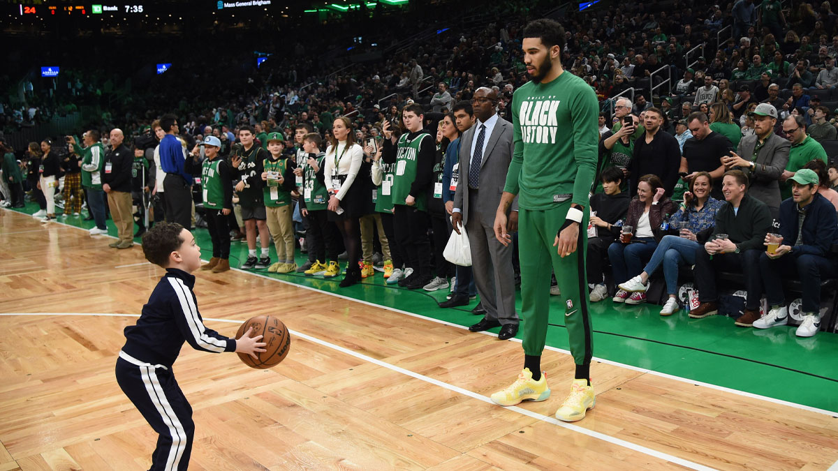 Boston Celtics forward Jayson Tatum (0) and his son Deuce prior to a game against the Charlotte Hornets at TD Garden.
