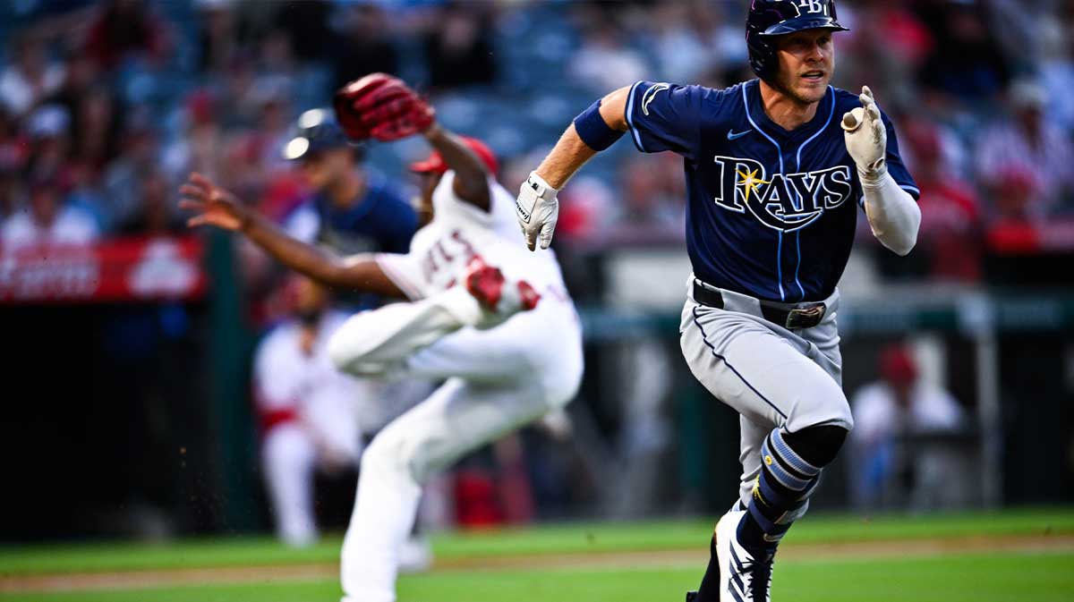 Tampa Bay Rays shortstop Taylor Walls (6) sprints to first after a bunt as Los Angeles Angels starting pitcher Jose Soriano (59) attempts to field the ball during the fourth inning at Angel Stadium of Anaheim.