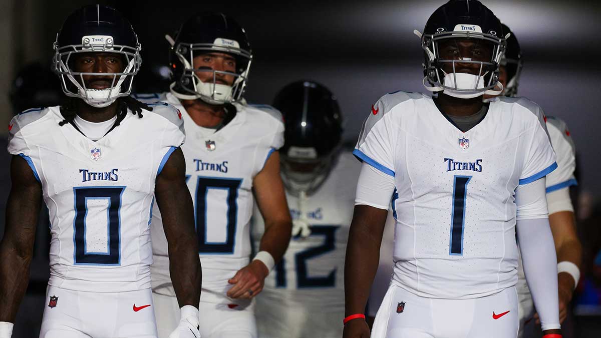 Tennessee Titans wide receiver Calvin Ridley (0) and quarterback Cameron Ward (1) take the field for warmups before a preseason game against the Tampa Bay Buccaneers at Raymond James Stadium.