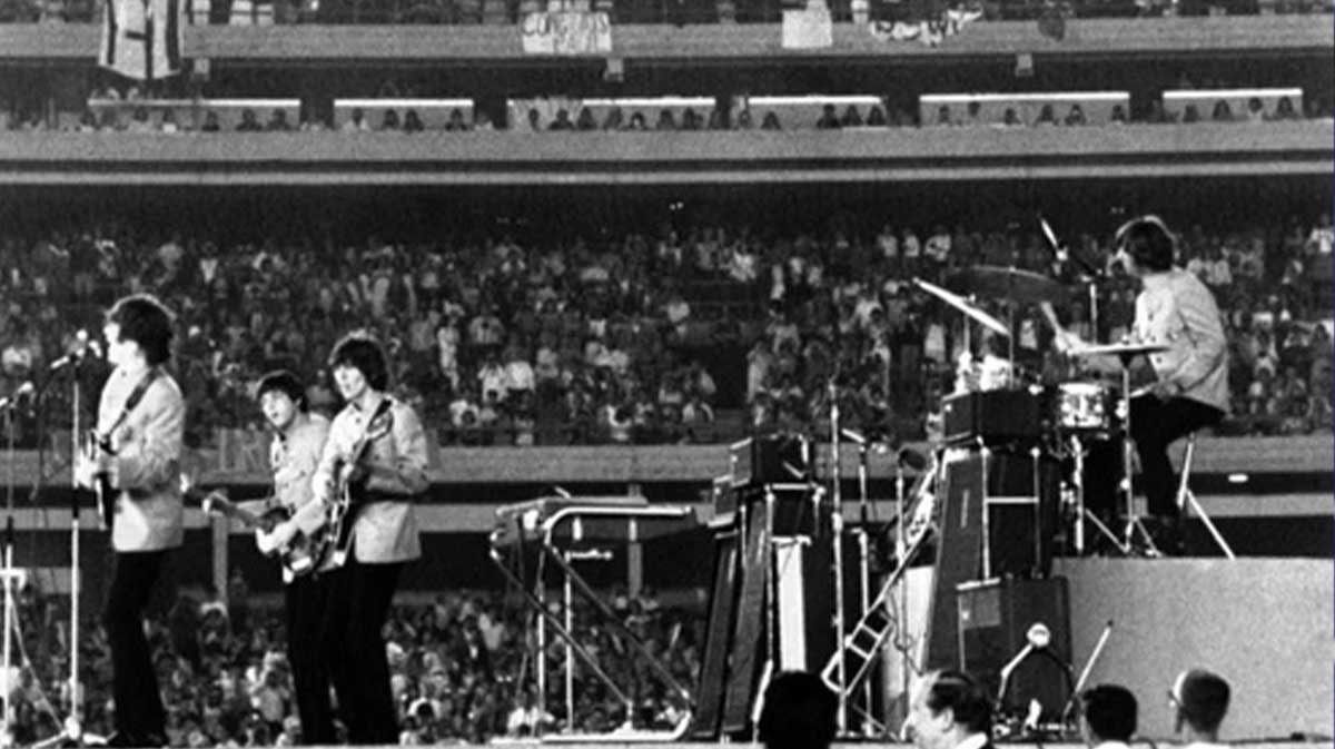 The Beatles — John Lennon, Paul McCartney, George Harrison, and Ringo Starr — playing a show as their iconic Shea Stadium concert will be honored by the New York Mets on August 15.