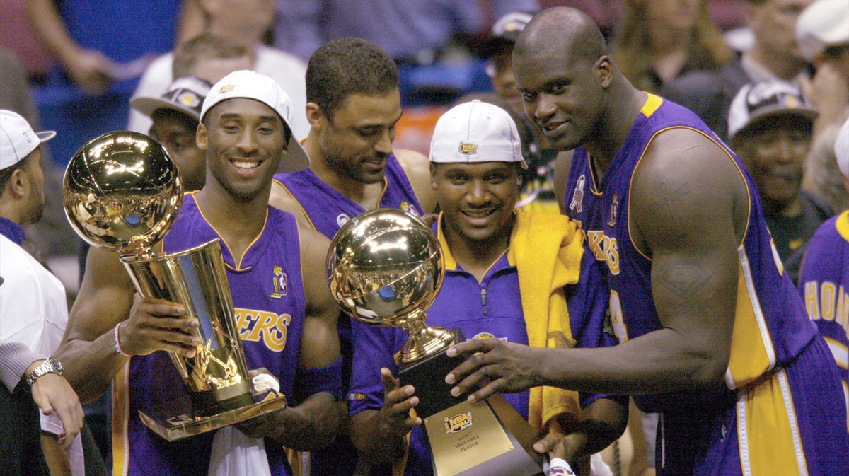 Los Angeles Lakers Kobe Bryant, Lindsay Hunter and Shaquille O'Neal hold championship trophies after winning Game 4 of the NBA Finals at The Meadowlands.