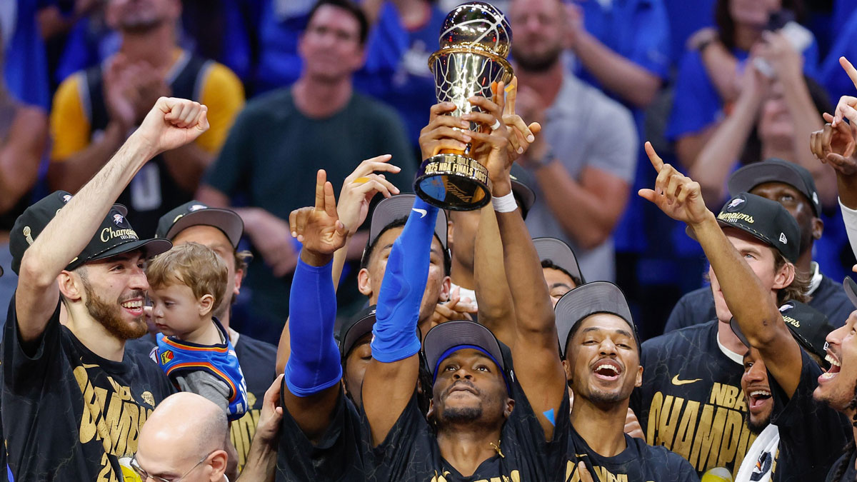 Thunder guard Shai Gilgeous-Alexander (2) holds up his NBA Finals Bill Russell MVP trophy at the end of game seven of the 2025 NBA Finals after defeating the Indiana Pacers at Paycom Center