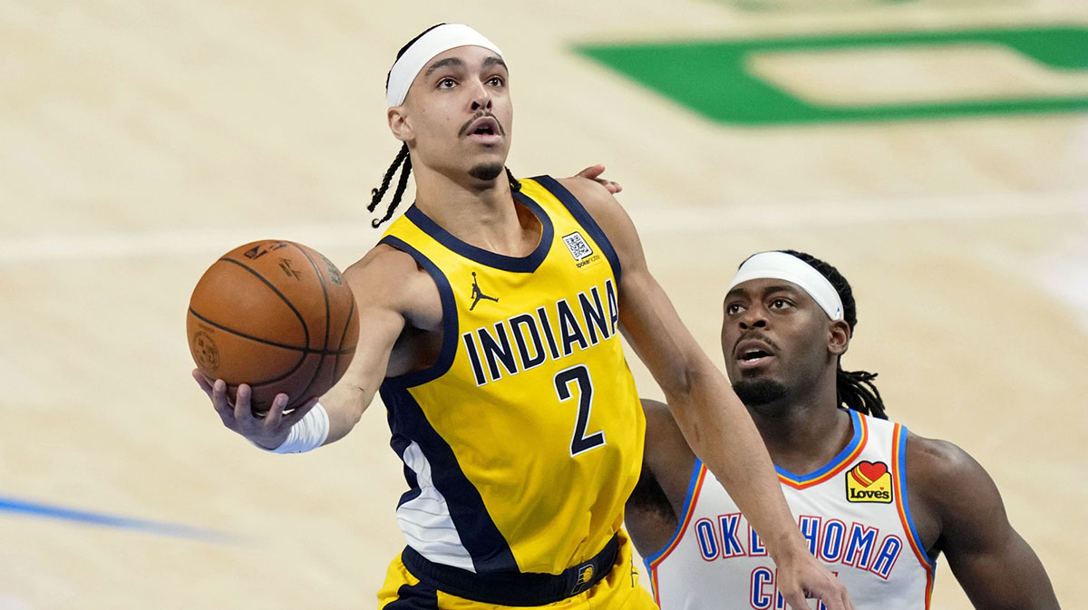 Pacers guard Andrew Nembhard (2) shoots the ball against Oklahoma City Thunder guard Luguentz Dort (5) during the third quarter in game one of the 2025 NBA Finals at Paycom Center with Pacers' Ben Mathurin in the background
