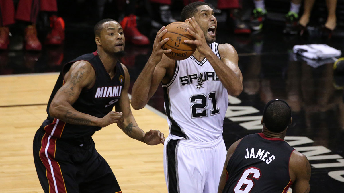 San Antonio Spurs forward Tim Duncan (21) shoots against Miami Heat forward LeBron James (6) and Rashard Lewis (9) in game two of the 2014 NBA Finals at AT&T Center.
