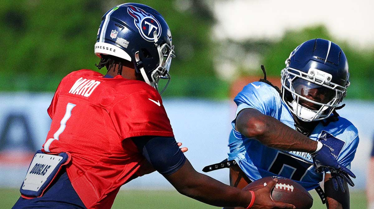 Tennessee Titans quarterback Cam Ward (1) hands the ball off to wide receiver Calvin Ridley (0) during an NFL football training camp practice at Ascension Saint Thomas Sports Park