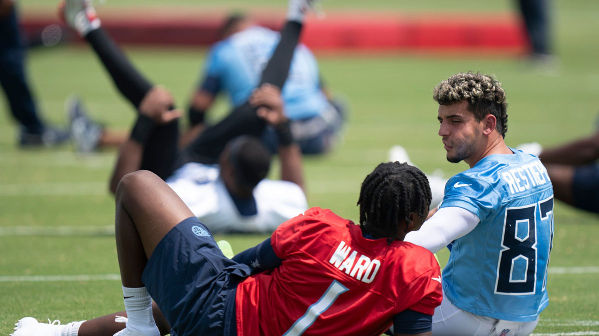 Tennessee Titans quarterback Cam Ward (1) and wide receiver Xavier Restrepo (87) stretch during OTAs at Ascension Saint Thomas Sports Park in Nashville, Tenn., Tuesday, June 3, 2025.