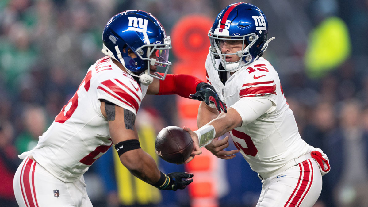 New York Giants quarterback Tommy DeVito (15) hands off to running back Saquon Barkley (26) during the first quarter against the Philadelphia Eagles at Lincoln Financial Field.