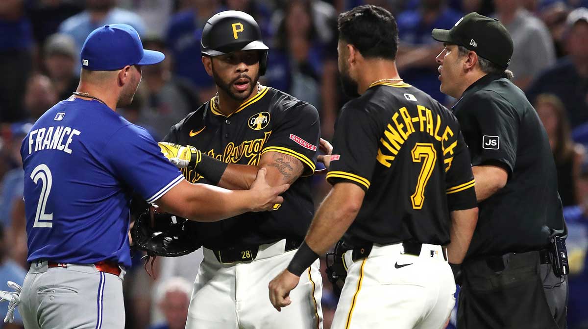 Pittsburgh Pirates left fielder Tommy Pham (middle) is restrained by Toronto Blue Jays first baseman Ty France (2) after Pham took exception to a comment by Toronto catcher Tyler Heineman (not pictured) during the seventh inning at PNC Park.
