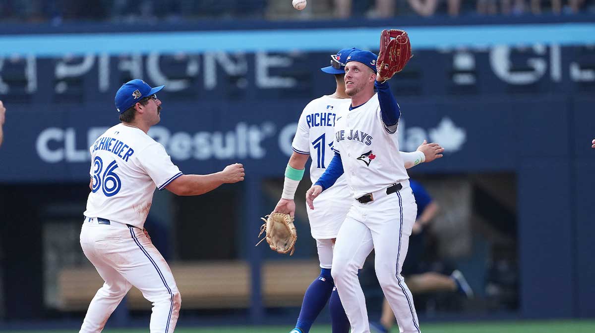Toronto Blue Jays centre fielder Myles Straw (3) celebrates the win with left fielder Davis Schneider (36) against the Texas Rangers at the end of the ninth inning at Rogers Centre.
