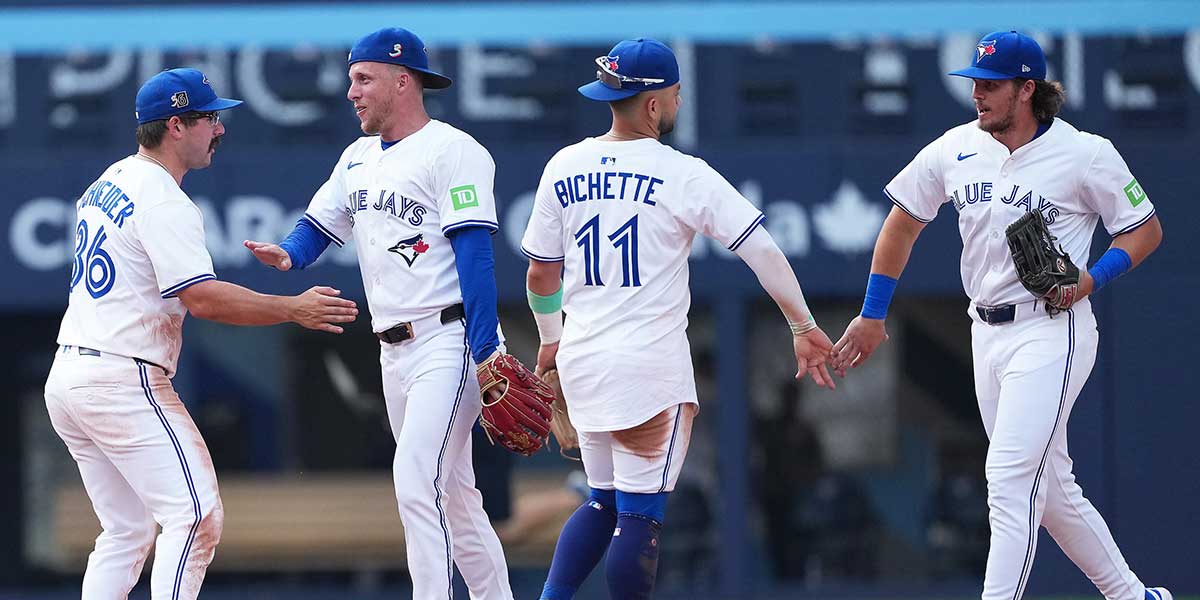 Toronto Blue Jays centre fielder Myles Straw (3) celebrates the win with left fielder Davis Schneider (36) against the Texas Rangers at the end of the ninth inning at Rogers Centre.