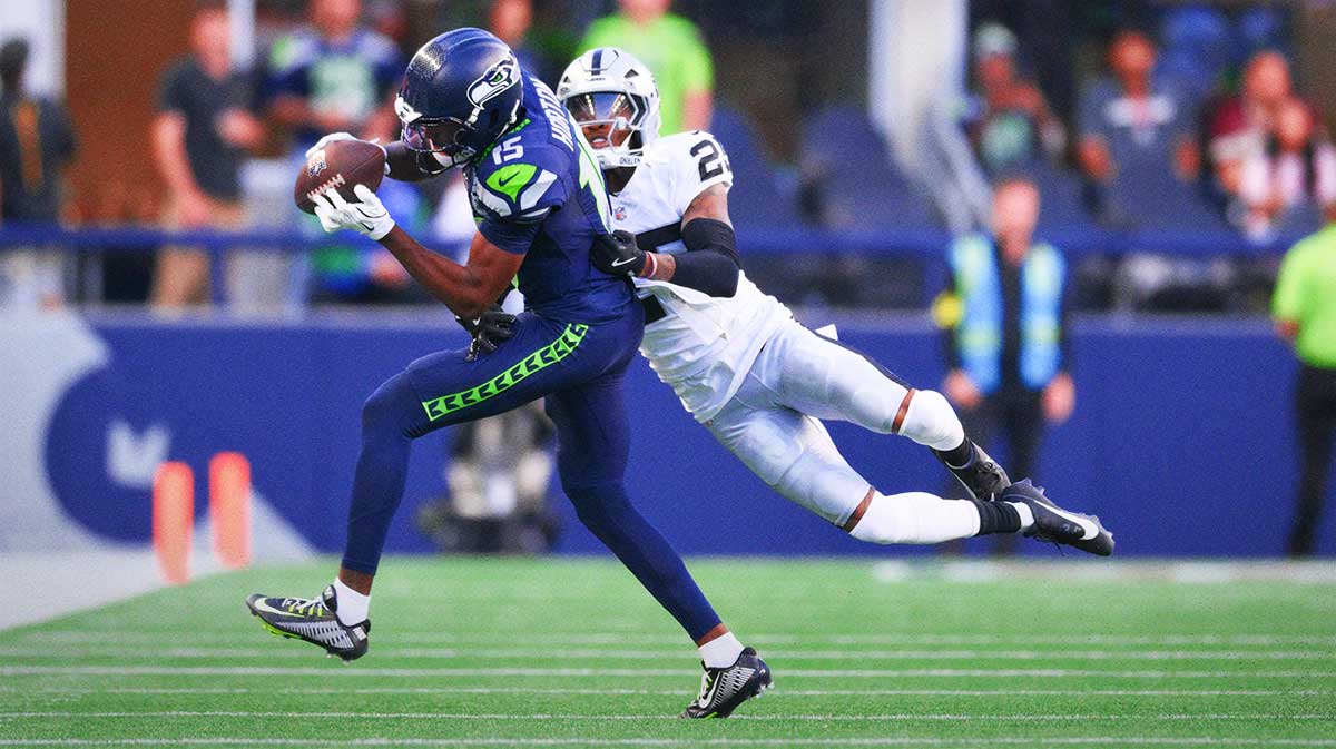 Seattle Seahawks wide receiver Tory Horton (15) catches a pass while covered by Las Vegas Raiders cornerback Decamerion Richardson (25) during the first half at Lumen Field.