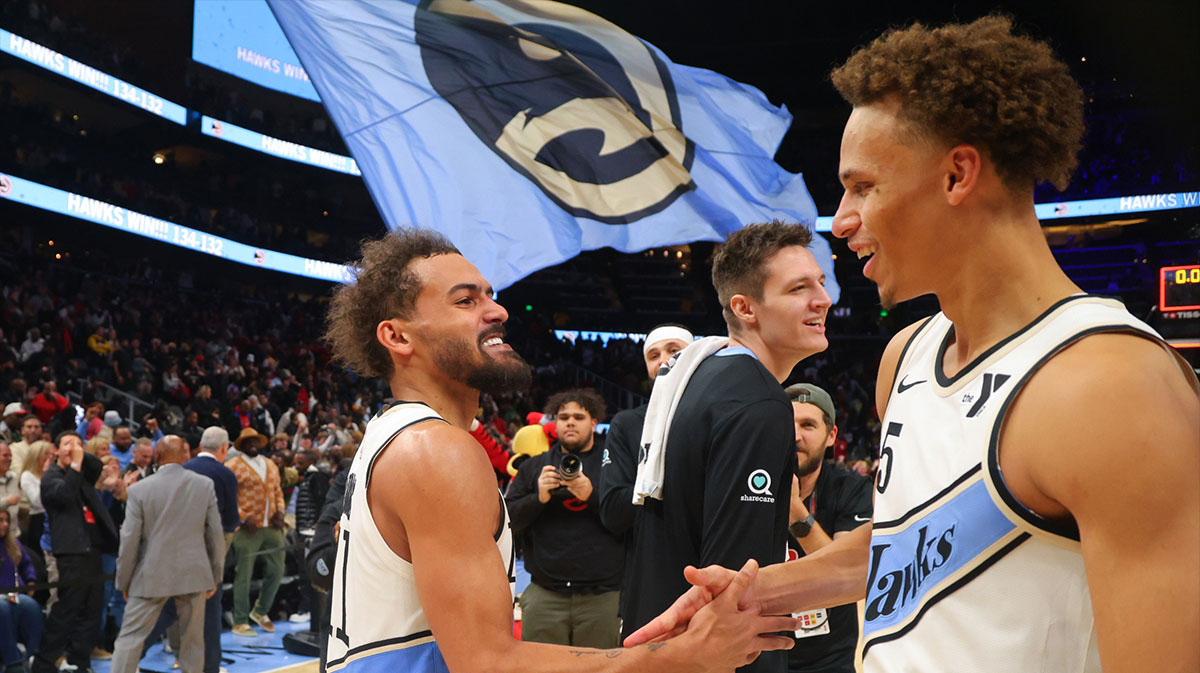 Atlanta Hawks guard Trae Young (11) celebrates with guard Dyson Daniels (5) after an overtime victory over the Los Angeles Lakers at State Farm Arena.