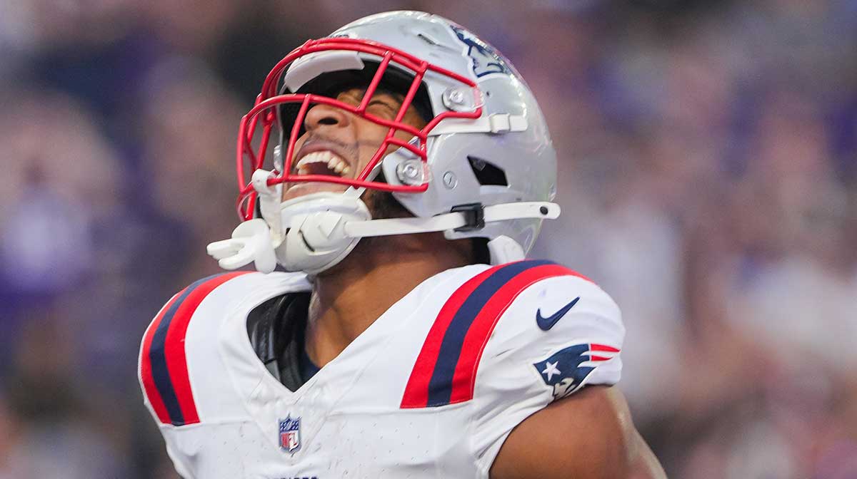 New England Patriots running back TreVeyon Henderson (32) celebrates his touchdown against the Minnesota Vikings in the first quarter at U.S. Bank Stadium.