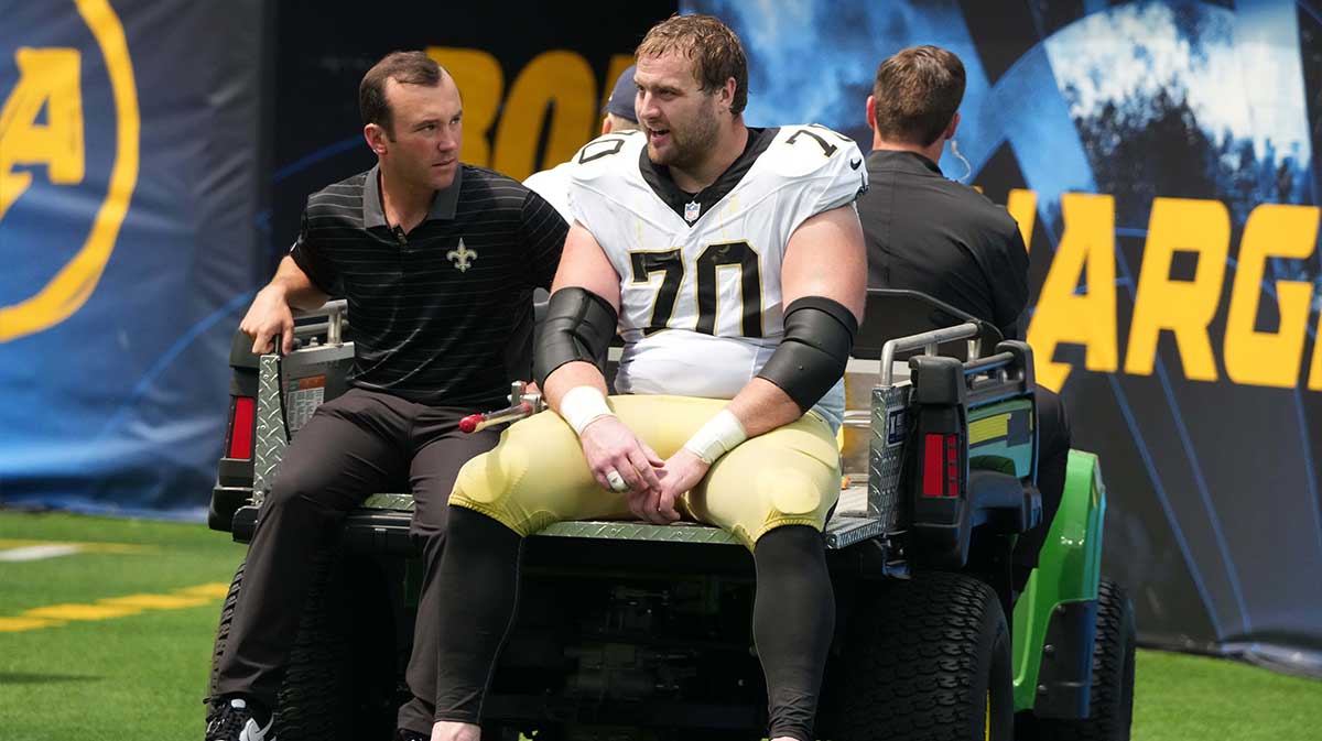 New Orleans Saints offensive tackle Trevor Penning (70) leaves the field with an injury in the first half against the Los Angeles Chargers at SoFi Stadium.