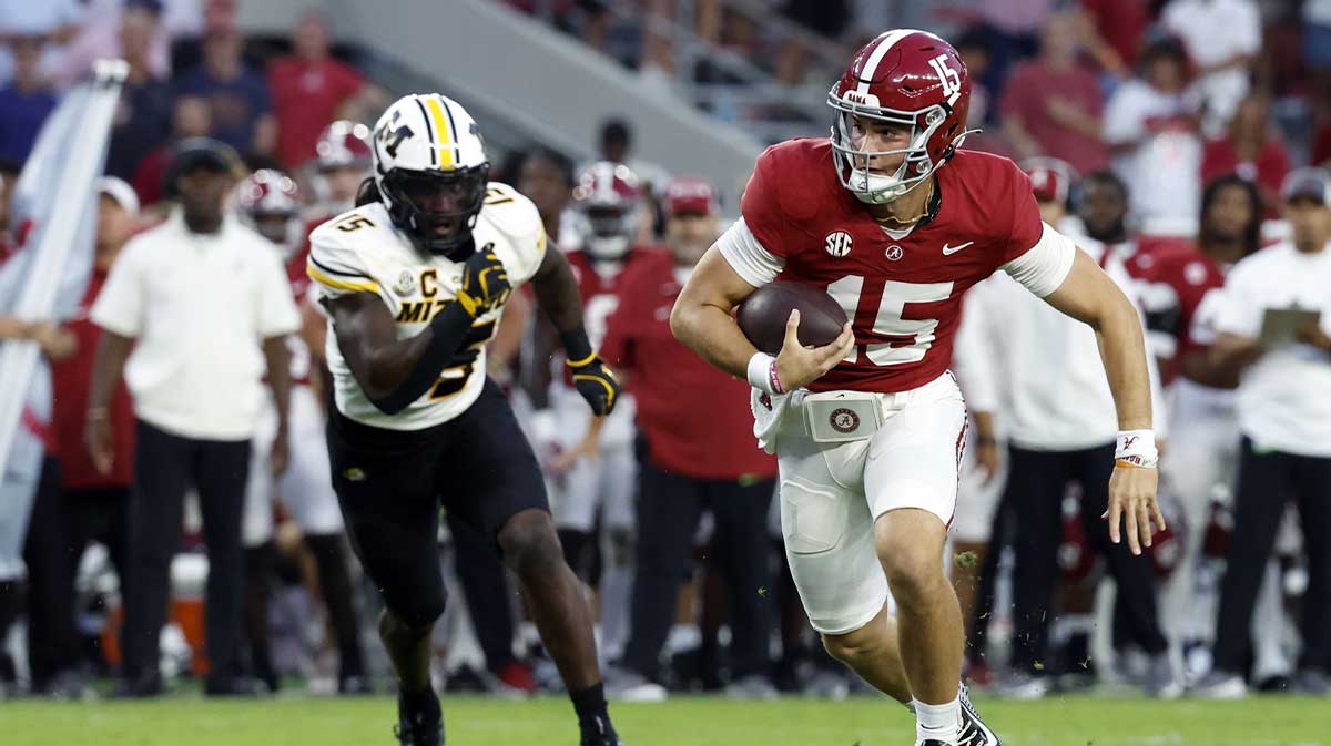 Alabama Crimson Tide quarterback Ty Simpson (15) scrambles for a first down against the Missouri Tigers during the second half at Bryant-Denny Stadium.