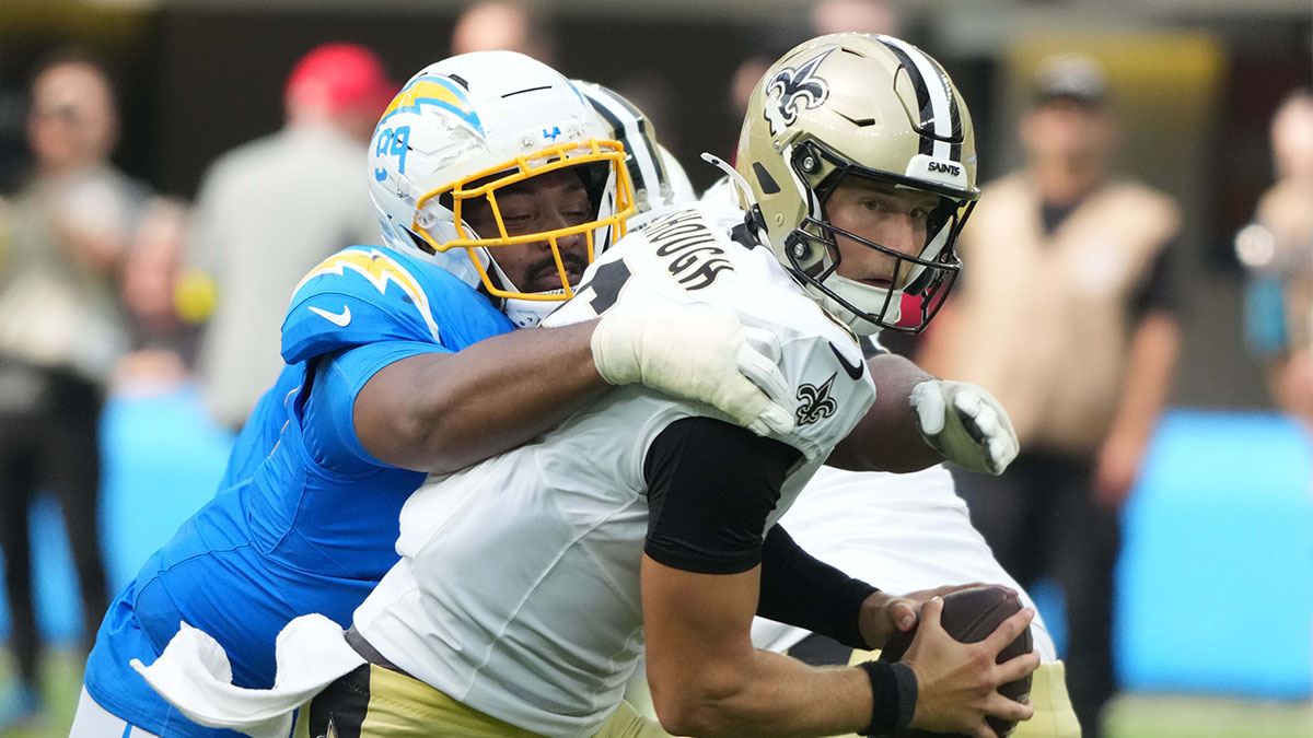 Los Angeles Chargers defensive tackle Jamaree Caldwell (99) sacks New Orleans Saints quarterback Tyler Shough (6) in the second half at SoFi Stadium.