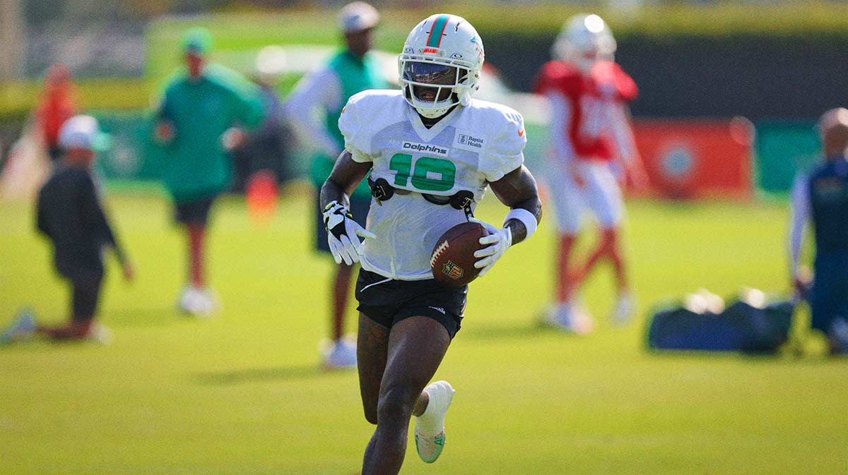 Miami Dolphins wide receiver Tyreek Hill (10) runs with the football during training camp at Baptist Health Training Complex.