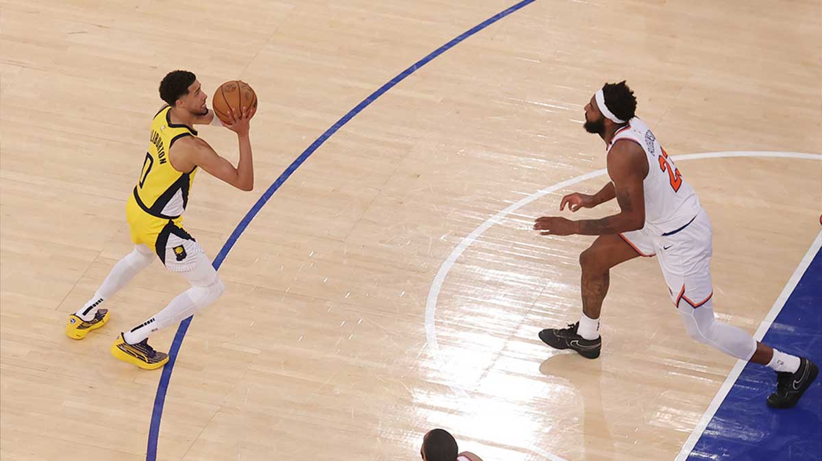 Indiana Pacers guard Tyrese Haliburton (0) shoots a game-tying two point shot to send the game to overtime in the fourth quarter against New York Knicks center Mitchell Robinson (23) during game one of the eastern conference finals for the 2025 NBA Playoffs at Madison Square Garden.