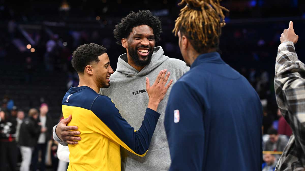 Philadelphia 76ers center Joel Embiid reacts with Indiana Pacers guard Tyrese Haliburton (left) and Indiana Pacers forward James Johnson (right) after the game