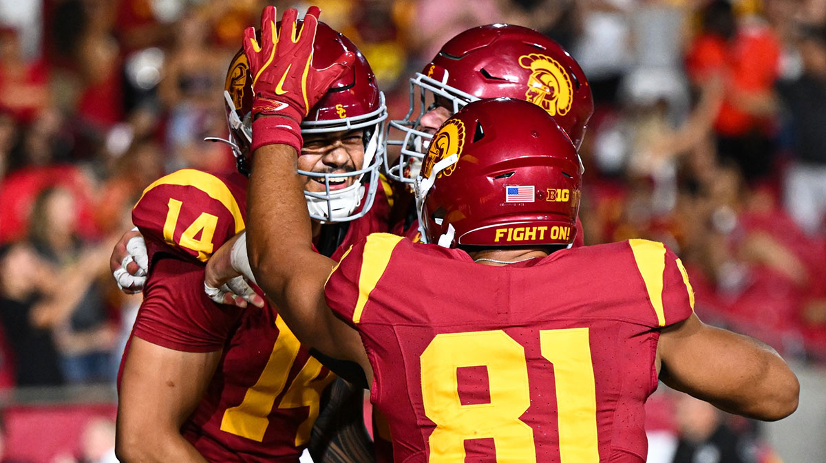USC Trojans quarterback Jayden Maiava (14) celebrates with teammates after scoring a touchdown against the Utah State Aggies during the fourth quarter at United Airlines Field at Los Angeles Memorial Coliseum.
