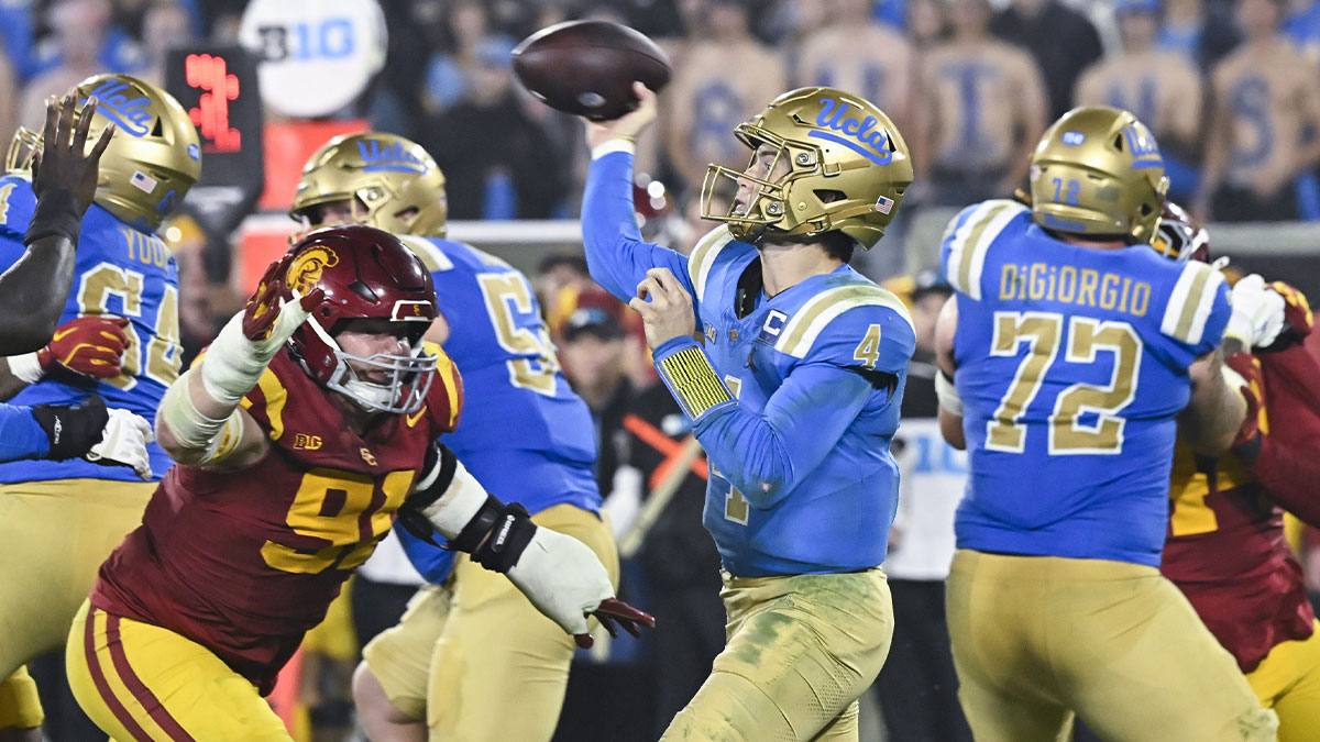 UCLA Bruins quarterback Ethan Garbers (4) throws a pass as USC Trojans defensive tackle Gavin Meyer (91) pressures him during the fourth quarter at Rose Bowl.