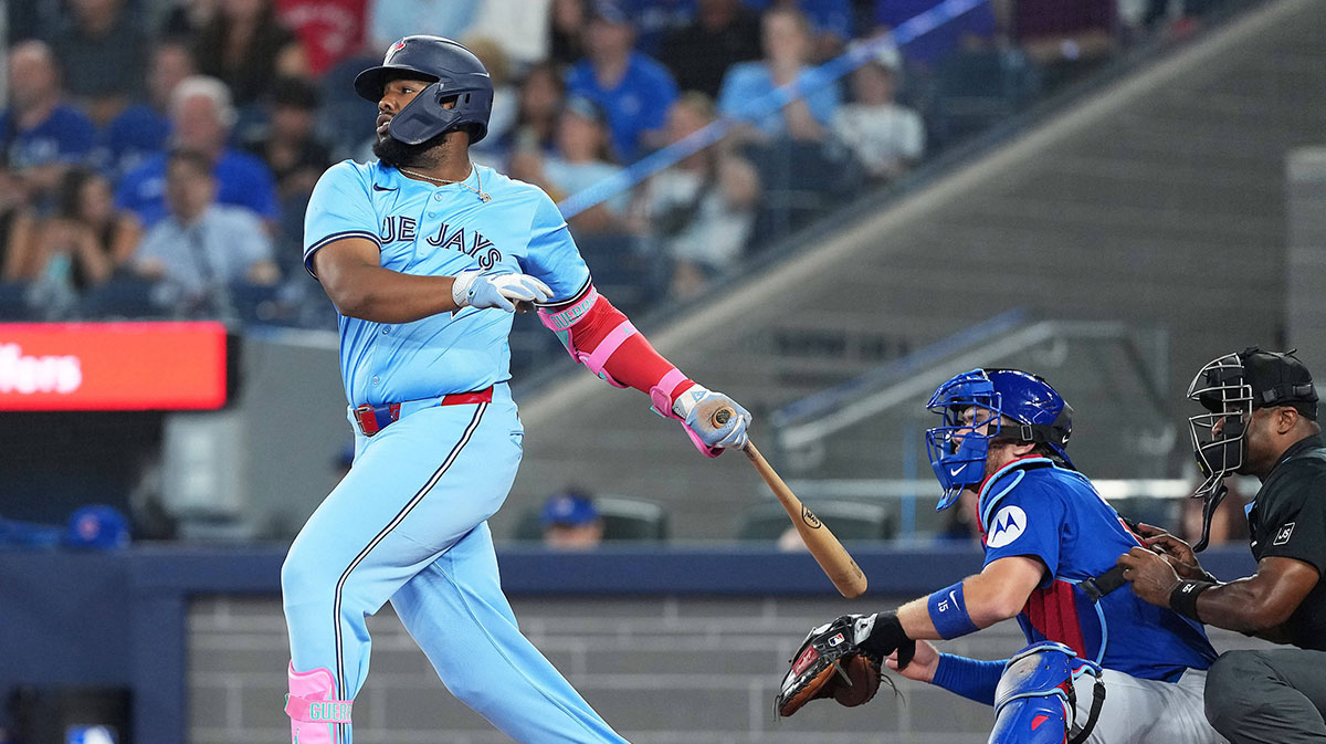 Toronto Blue Jays first baseman Vladimir Guerrero Jr. (27) hits a single against the Chicago Cubs during the first inning at Rogers Centre.