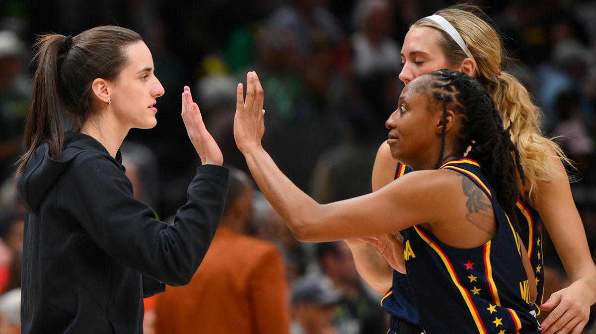 Indiana Fever guard Caitlin Clark (22) and guard Kelsey Mitchell (0) celebrate defeating the Seattle Storm at Climate Pledge Arena.