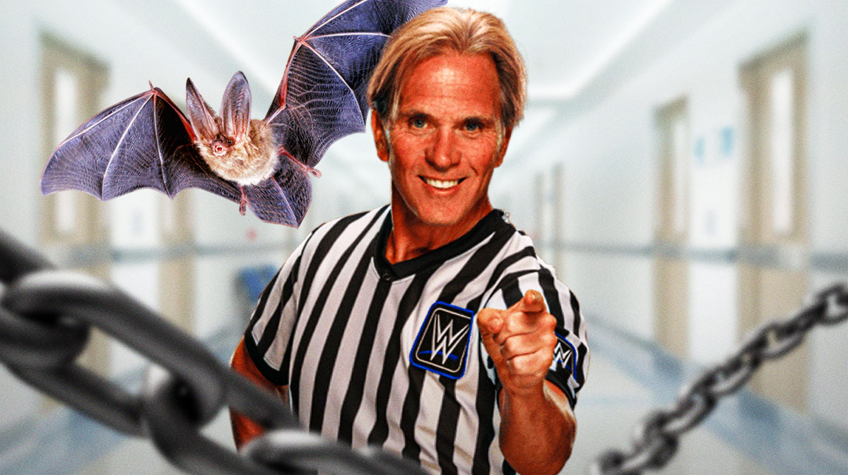 WWE referee Charles Robinson next to a bat.