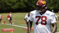 Washington Commanders offensive tackle Laremy Tunsil (78) stands on the field on day one of minicamp at Commanders Park.