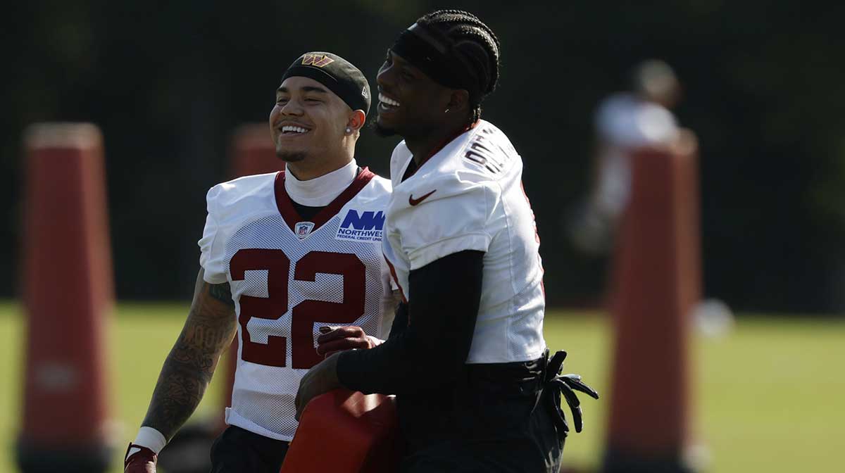 Washington Commanders running back Brian Robinson Jr. (8) jokes with Commanders cornerback Car'lin Vigers (22) during practice on day two of training camp at OrthoVirginia Training Center at Commanders Park.