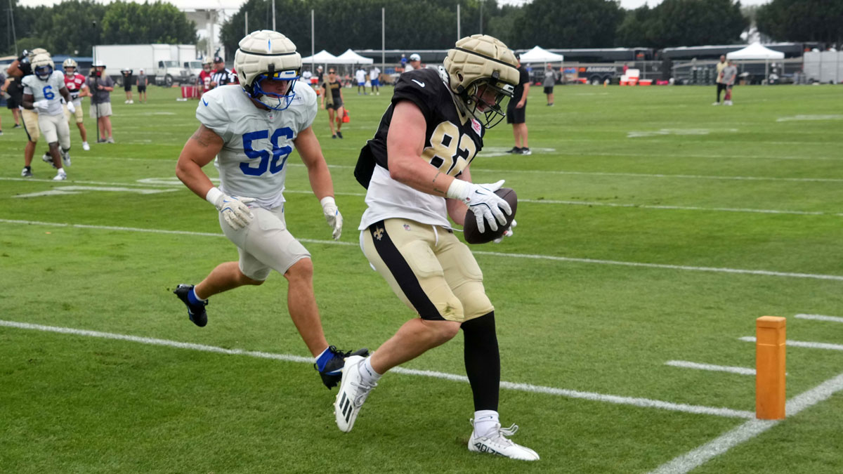 New Orleans Saints tight end Treyton Welch (82) catches a touchdown pass against Los Angeles Rams linebacker Shaun Dolac (56) during a joint practice at the Dignity Health Sports Park.